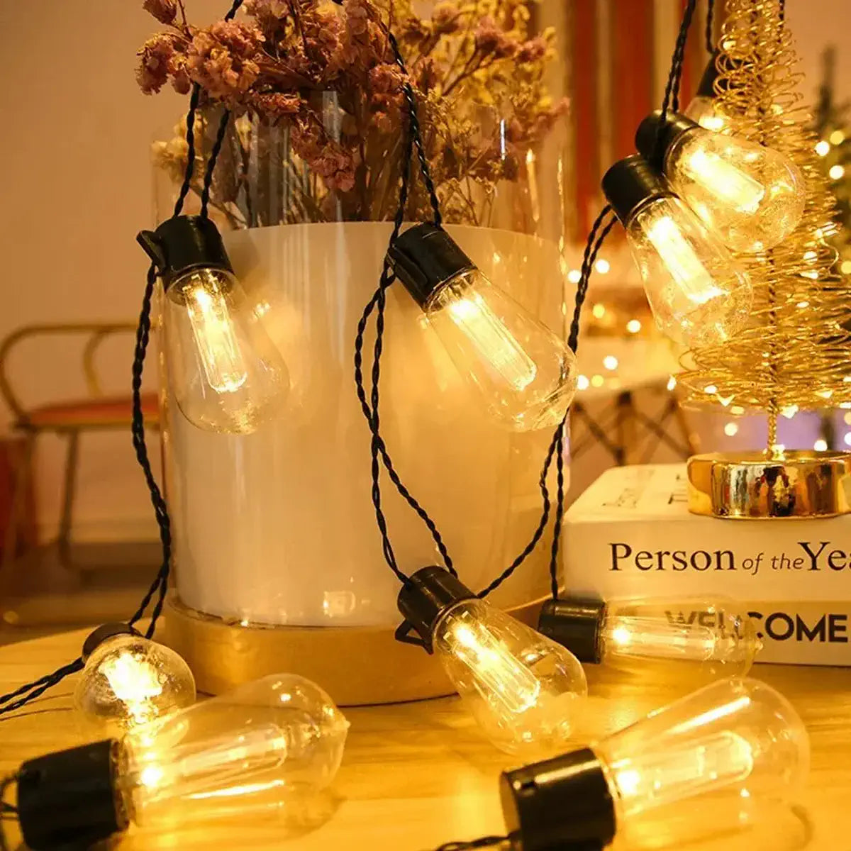 Warm bulbs glowing beside a tabletop decoration