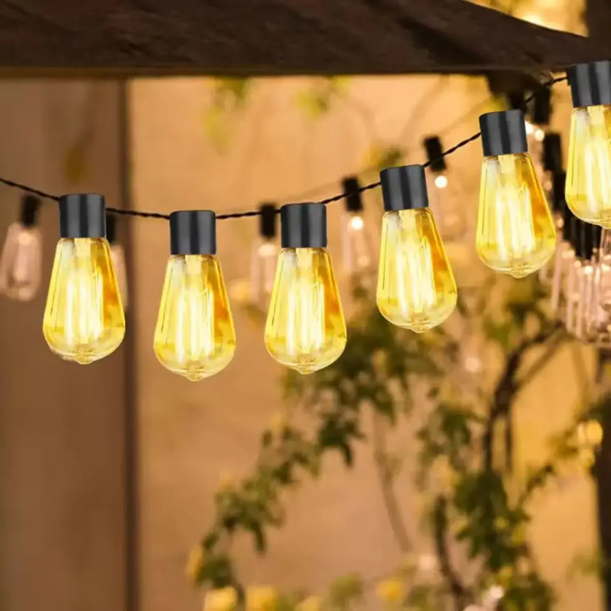 Warm Edison-style solar string lights near a patio roof
