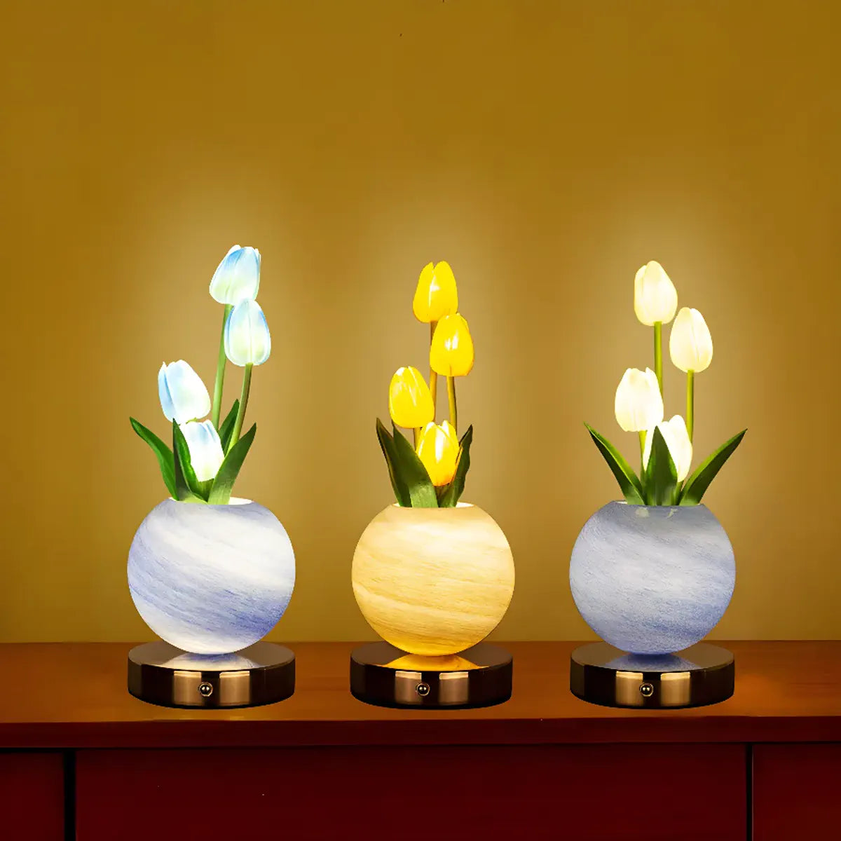 Three glowing tulip lamp styles on round bases