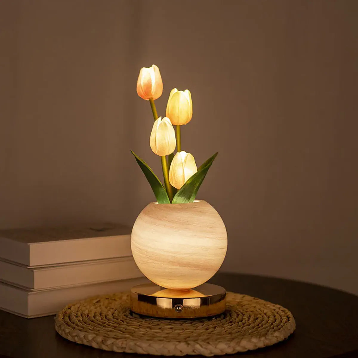 Orange tulip lamp glowing on a bedside table
