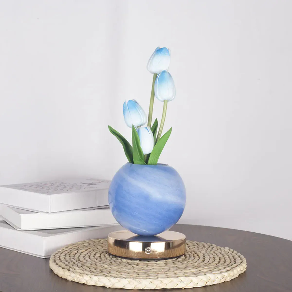 Unlit blue tulip bouquet in a round globe base