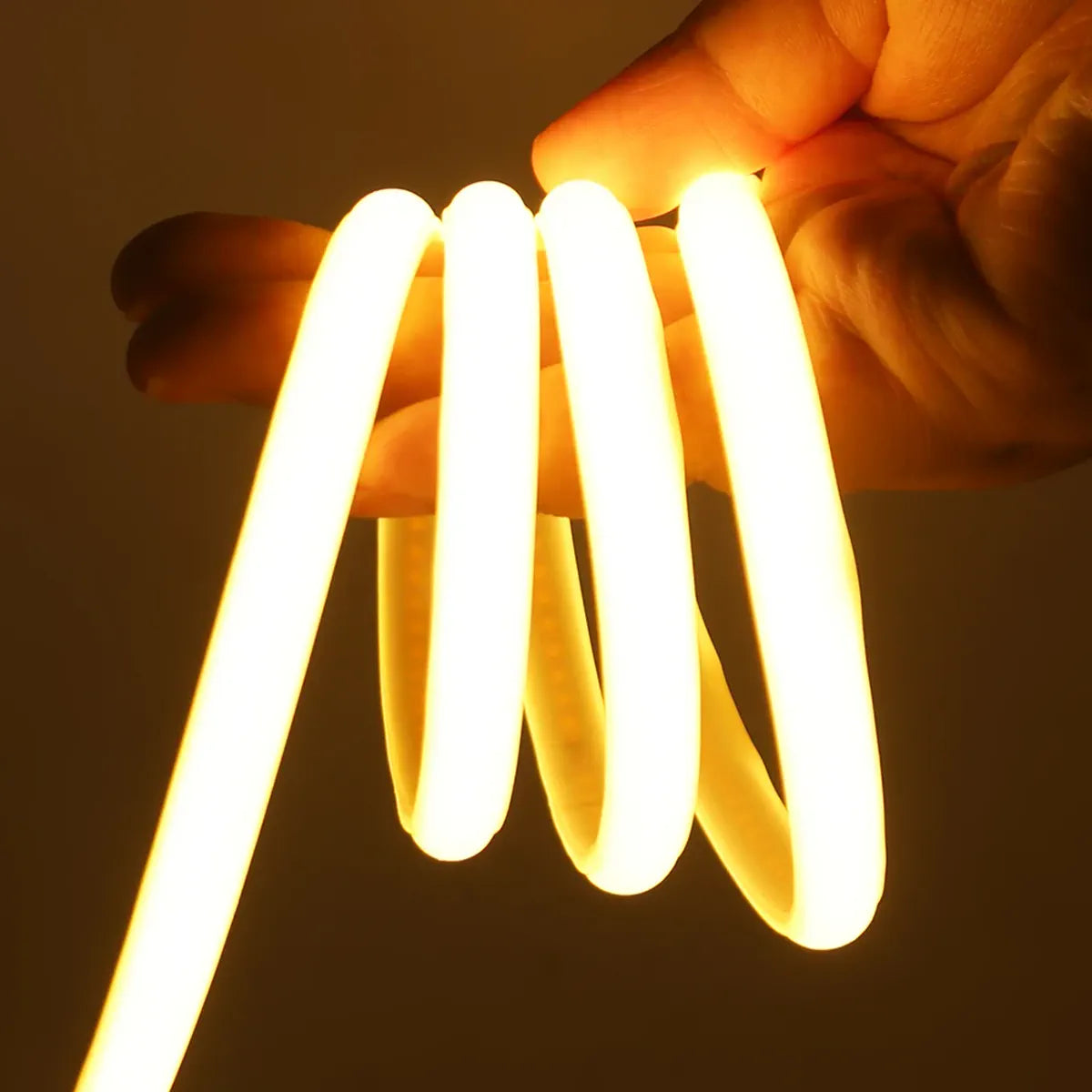 Flexible warm COB neon strip wrapped around a hand