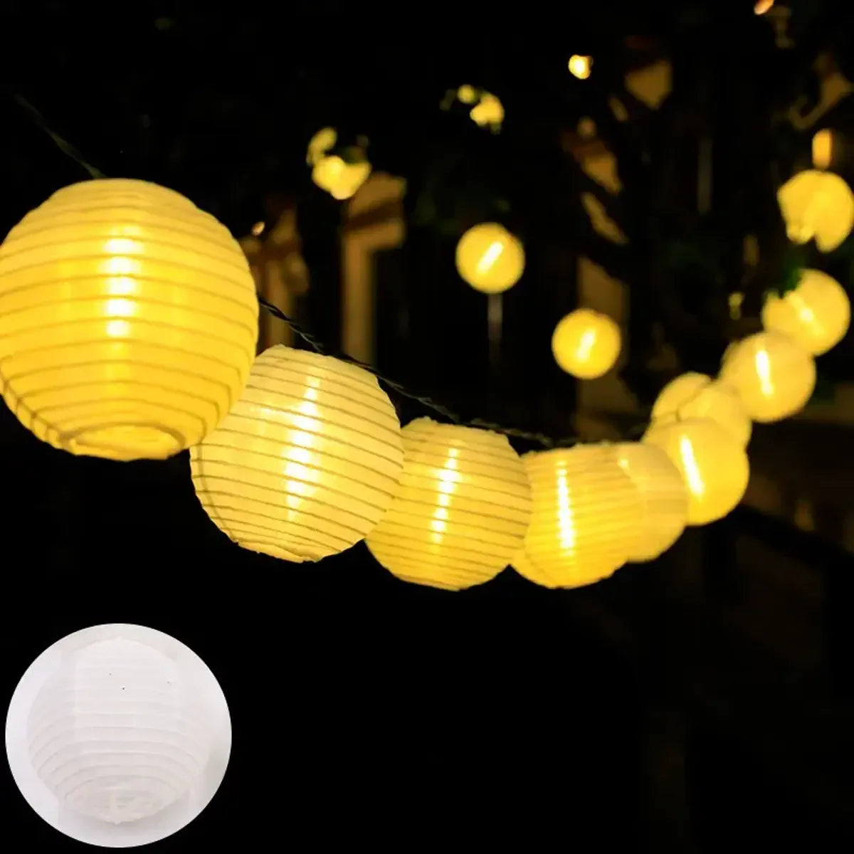 Warm white solar lanterns hanging outdoors at night
