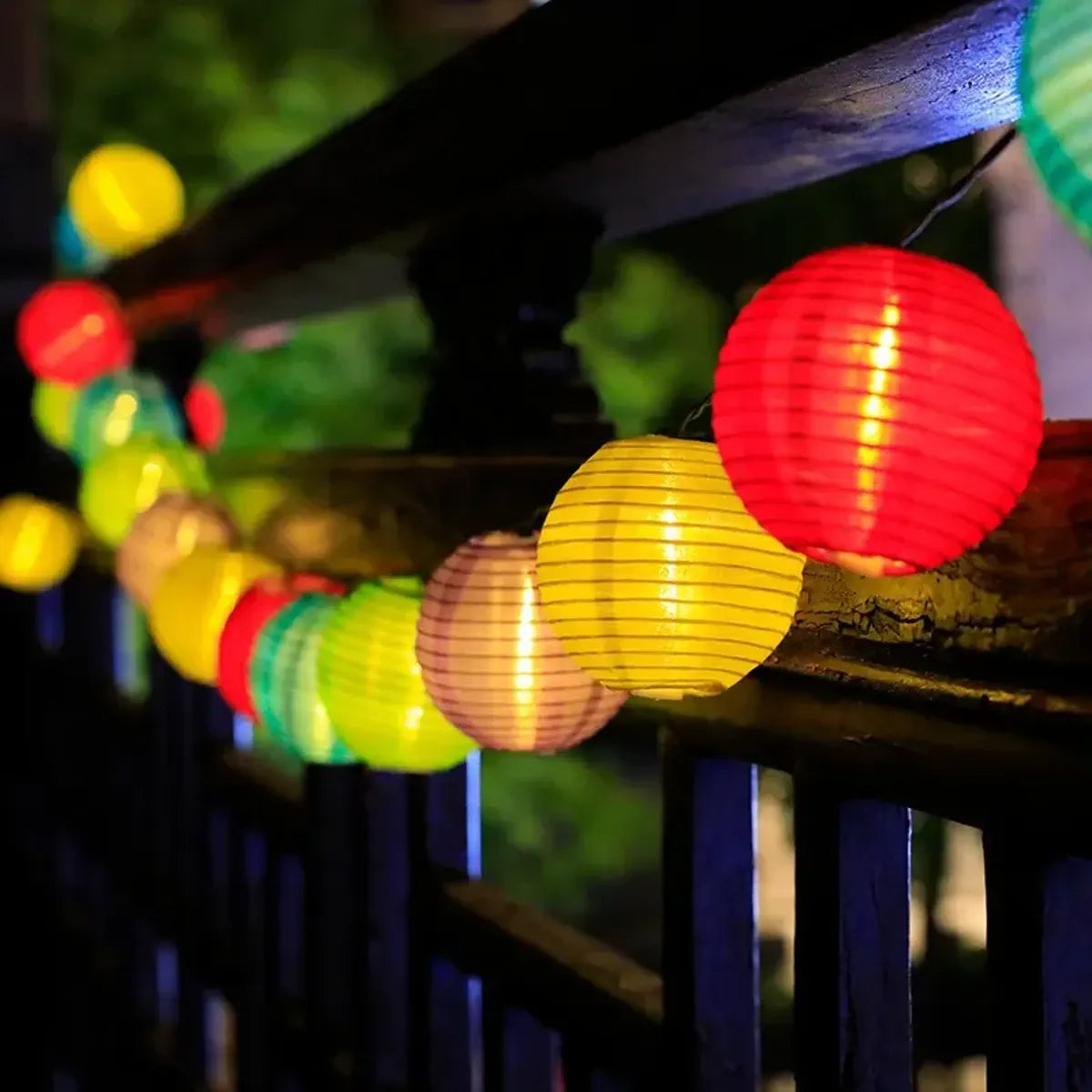 Colorful lantern string lights running along an outdoor railing