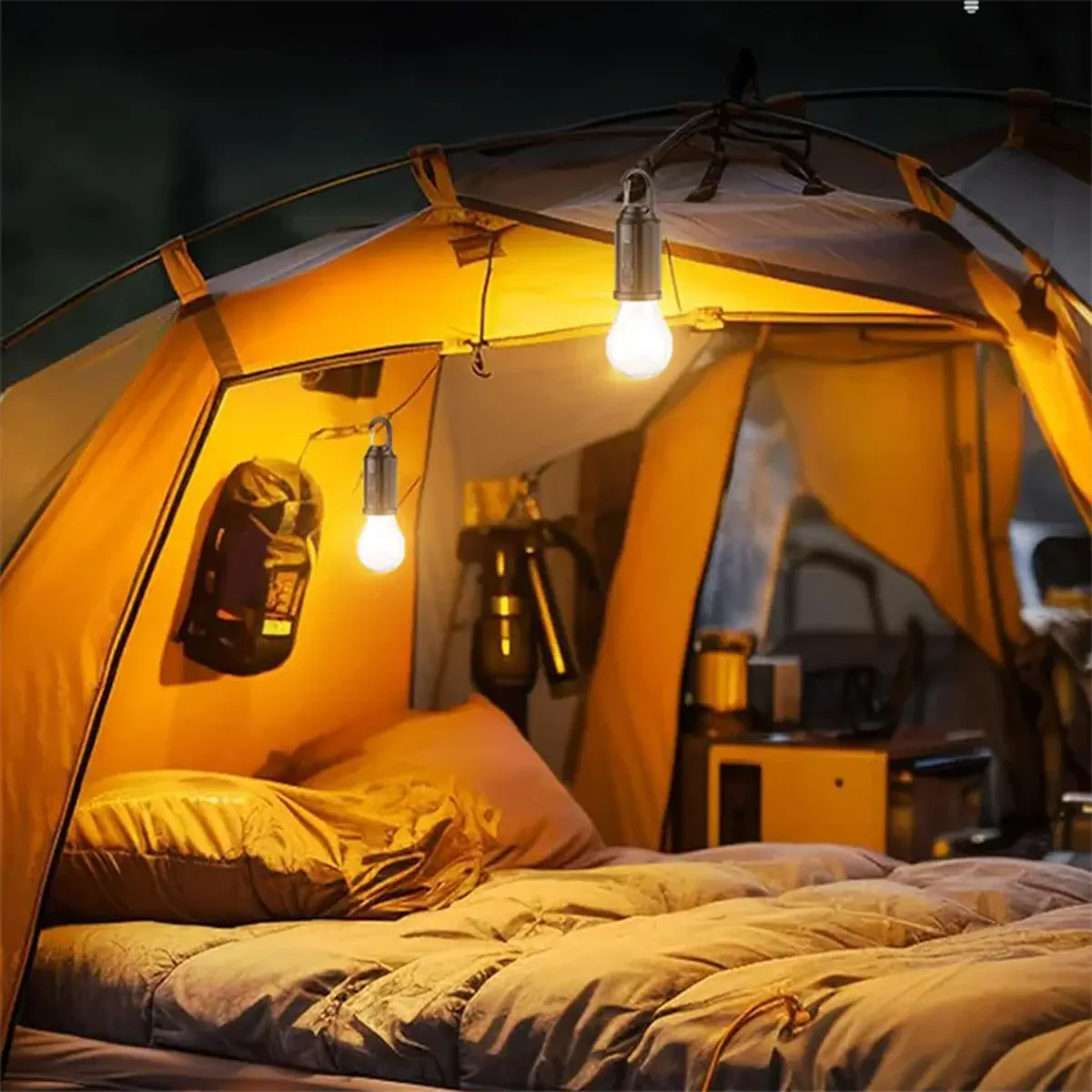 Hanging LED camping bulbs lighting a tent interior